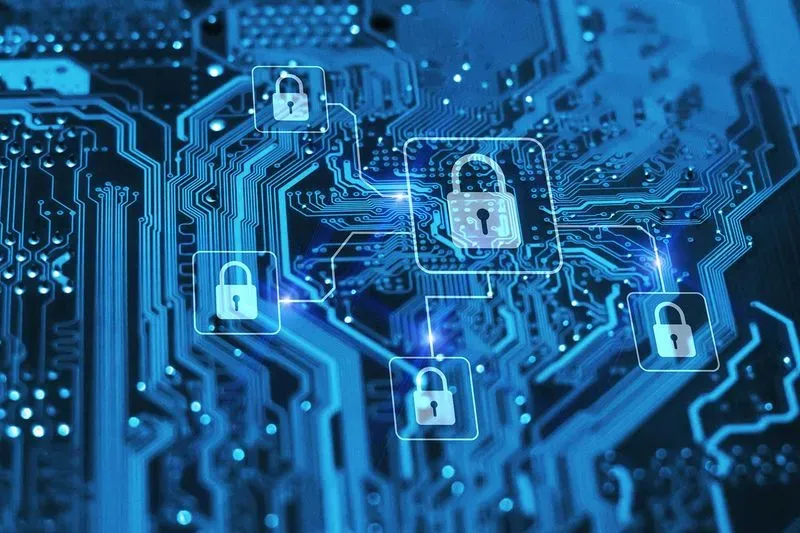 A close-up of a blue circuit board featuring digital lock icons, symbolizing cybersecurity and data protection.