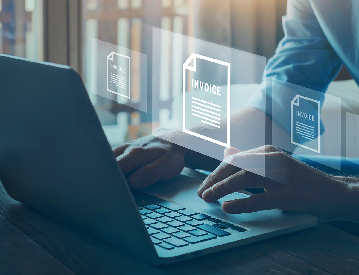 A person reviewing digital invoices on a laptop.